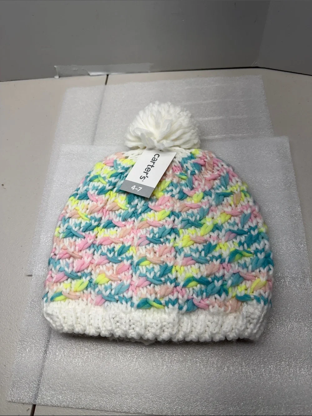 Carter's White Pom-Pom Beanie with Pastel Pink, Blue, Yellow and Mint Stripes